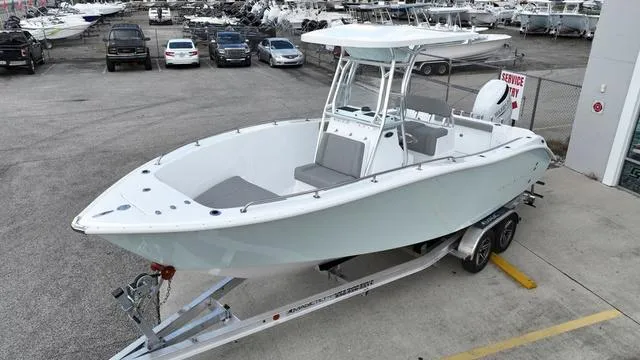 Slide: The Image of 2024 Cape Horn 22OS boat on a trailer in a marina parking lot. - 10