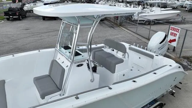 Slide: The Image of 2024 Cape Horn 22OS boat with seating and T-top in a marina. - 11