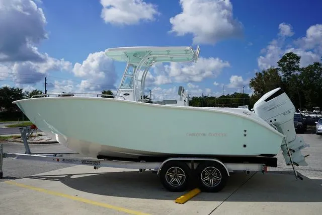 Slide: The Image of 2024 Cape Horn 22OS boat on a trailer under a blue sky. - 18