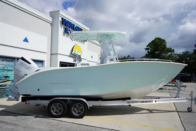 Slide: The Image of 2024 Cape Horn 22OS boat on trailer outside dealership under cloudy sky. - 19