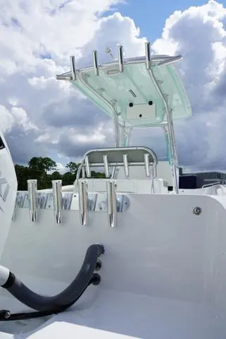 Slide: The Image of 2024 Cape Horn 22OS boat with rod holders and T-top against a cloudy sky. - 23