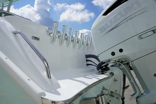 Slide: The Image of 2024 Cape Horn 22OS boat with Suzuki outboard motor under a blue sky. - 28