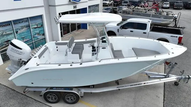 Slide: The Image of 2024 Cape Horn 22OS boat on trailer, parked outside dealership. - 3
