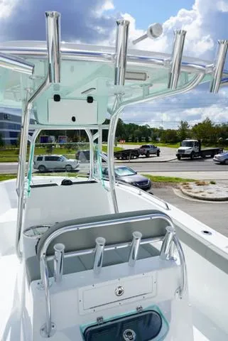 Slide: The Image of 2024 Cape Horn 22OS boat with T-top and rod holders in a parking lot. - 33