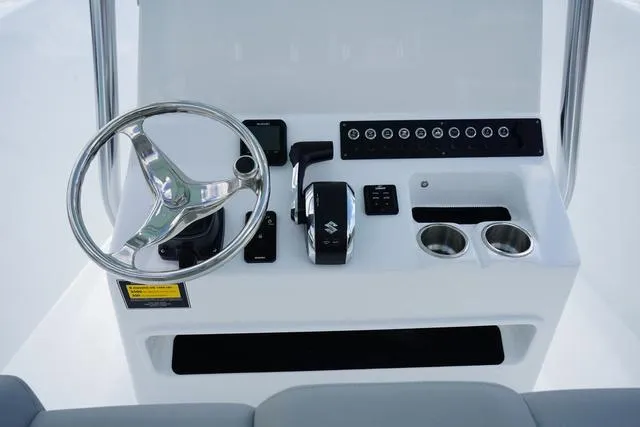 Slide: The Image of 2024 Cape Horn 22OS boat console with steering wheel and controls. - 41