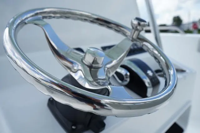 Slide: The Image of Close-up of the steering wheel on a 2024 Cape Horn 22OS boat. - 42
