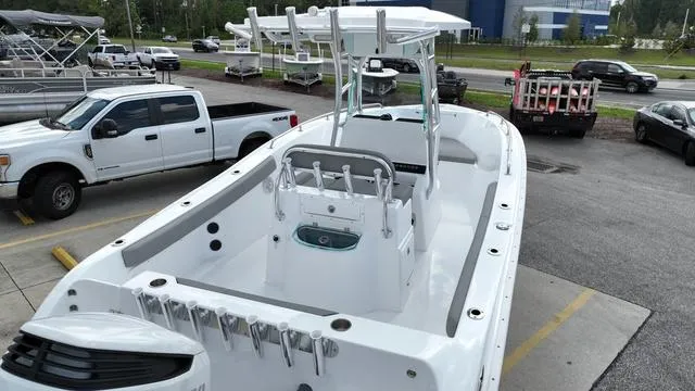 Slide: The Image of 2024 Cape Horn 22OS boat, white, docked in a marina parking lot. - 5