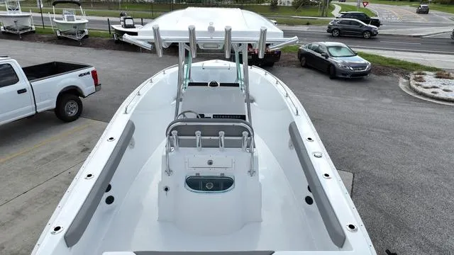 Slide: The Image of 2024 Cape Horn 22OS boat, top view, parked on a lot with surrounding vehicles. - 6