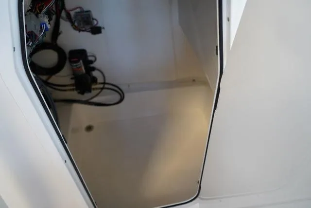 Slide: The Image of 2024 Sea Pro 222 CC boat interior compartment with wiring and equipment. - 11
