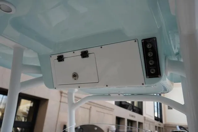 Slide: The Image of 2024 Sea Pro 222 CC center console storage compartment and control panel. - 13