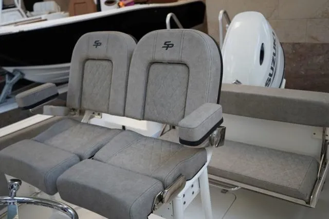 Slide: The Image of 2024 Sea Pro 222 CC boat with dual cushioned seats and armrests. - 21