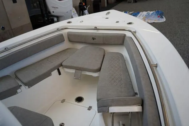Slide: The Image of 2024 Sea Pro 222 CC boat interior with cushioned seating and storage. - 22