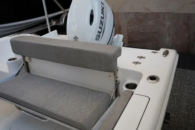 Slide: The Image of 2024 Sea Pro 222 CC boat with Suzuki outboard motor and cushioned seating. - 6