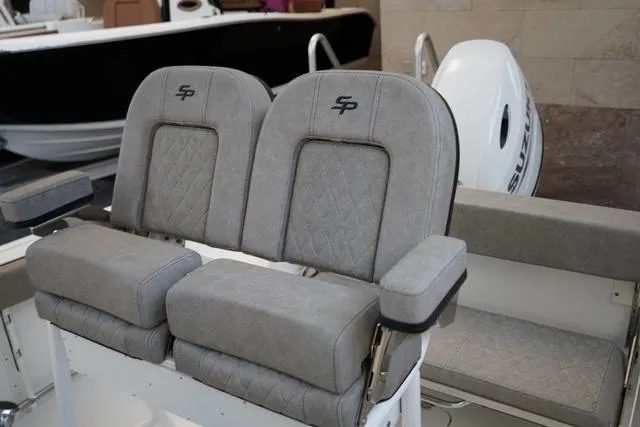 Slide: The Image of 2024 Sea Pro 222 CC boat with dual cushioned seats and Suzuki outboard motor. - 7