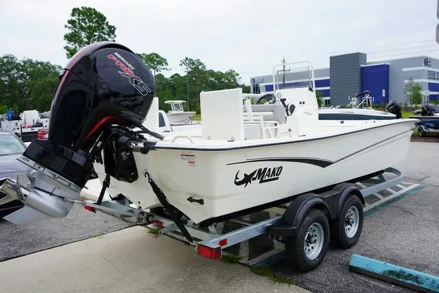 Slide: The Image of 2023 Mako 19 Pro Skiff boat on a trailer with a powerful outboard motor. - 20