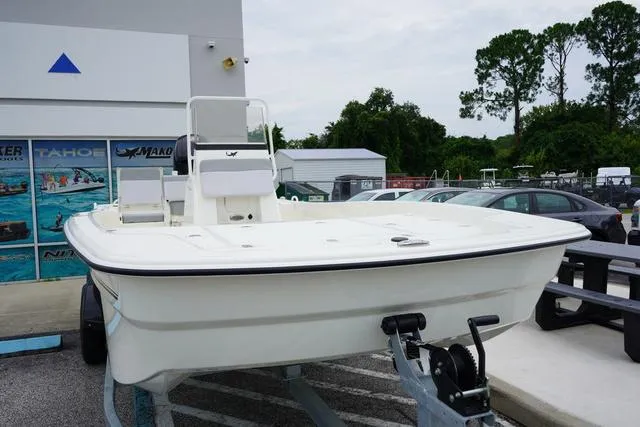 Slide: The Image of 2023 Mako 19 Pro Skiff boat on trailer outside dealership. - 22