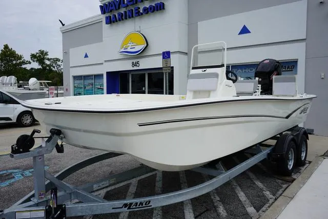 Slide: The Image of 2023 Mako 19 Pro Skiff boat on trailer outside Waylen Marine dealership. - 23
