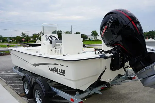 Slide: The Image of 2023 Mako 19 Pro Skiff boat on trailer with outboard motor. - 27