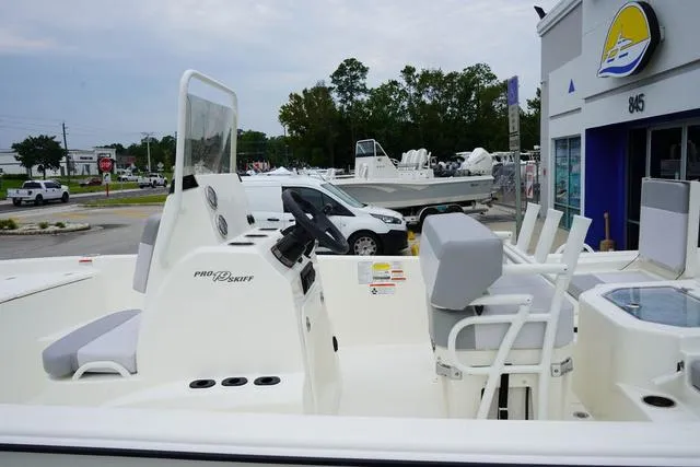 Slide: The Image of 2023 Mako 19 Pro Skiff boat on display at a dealership. - 29