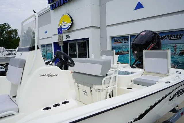 Slide: The Image of 2023 Mako 19 Pro Skiff boat displayed at a marine dealership. - 30