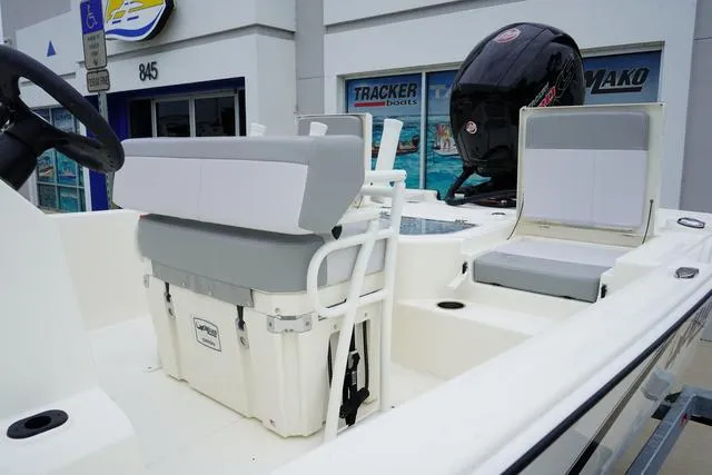 Slide: The Image of 2023 Mako 19 Pro Skiff boat interior with seating and outboard motor. - 31