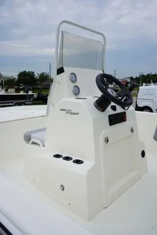 Slide: The Image of 2023 Mako 19 Pro Skiff center console with steering wheel and gauges. - 33