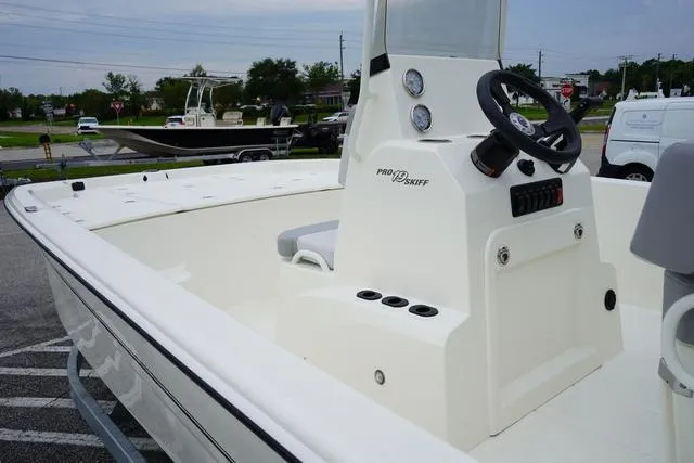 Slide: The Image of 2023 Mako 19 Pro Skiff boat interior with steering console and seating. - 34