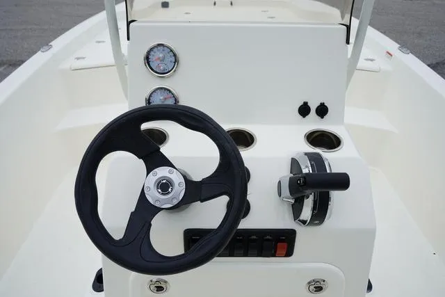 Slide: The Image of 2023 Mako 19 Pro Skiff boat console with steering wheel and gauges. - 40