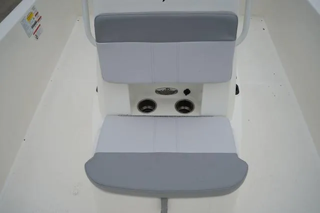 Slide: The Image of 2023 Mako 19 Pro Skiff boat seating area with cup holders. - 45