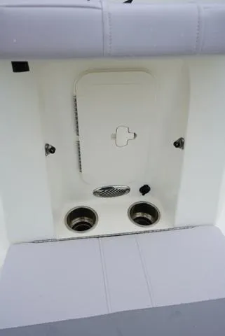 Slide: The Image of 2023 Mako 19 Pro Skiff boat interior with storage compartment and cup holders. - 49
