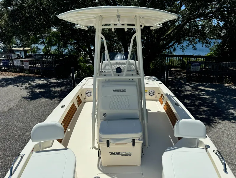 Slide: The Image of 2025 Pathfinder 2200 TRS boat with T-top, docked near trees and water. - 4