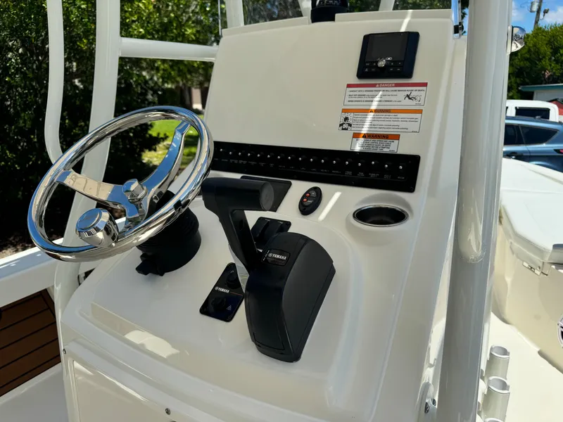 Slide: The Image of 2025 Pathfinder 2200 TRS boat console with steering wheel and controls. - 7