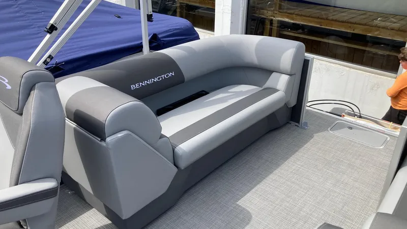 Slide: The Image of 2024 Bennington 22 SVSR pontoon boat with gray seating and carpeted deck. - 2