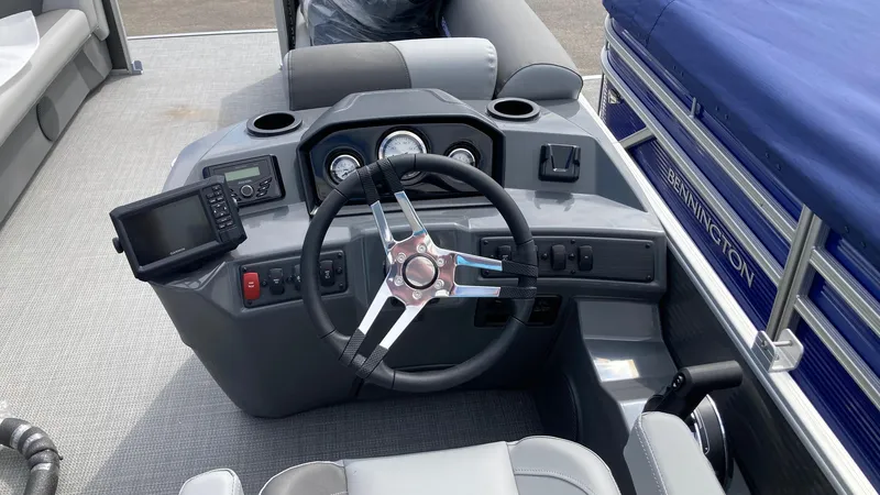 Slide: The Image of 2024 Bennington 22 SVSR boat dashboard with steering wheel and navigation controls. - 6