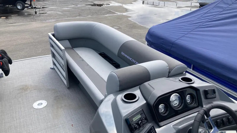 Slide: The Image of 2024 Bennington 22 SVSR pontoon boat interior with gray seating and control console. - 8