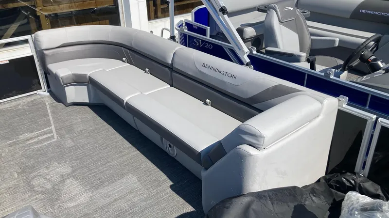 Slide: The Image of 2024 Bennington 21 SXSRC pontoon boat with spacious seating and modern design. - 2