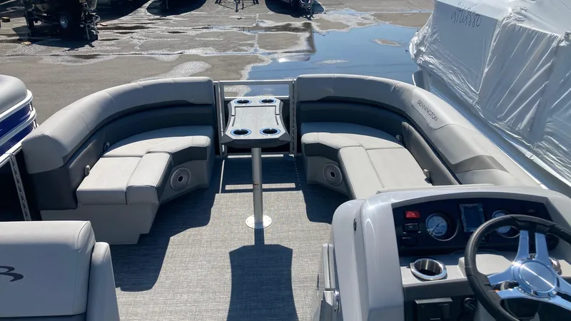 Slide: The Image of 2024 Bennington 21 SXSRC pontoon boat interior with seating and control console. - 3
