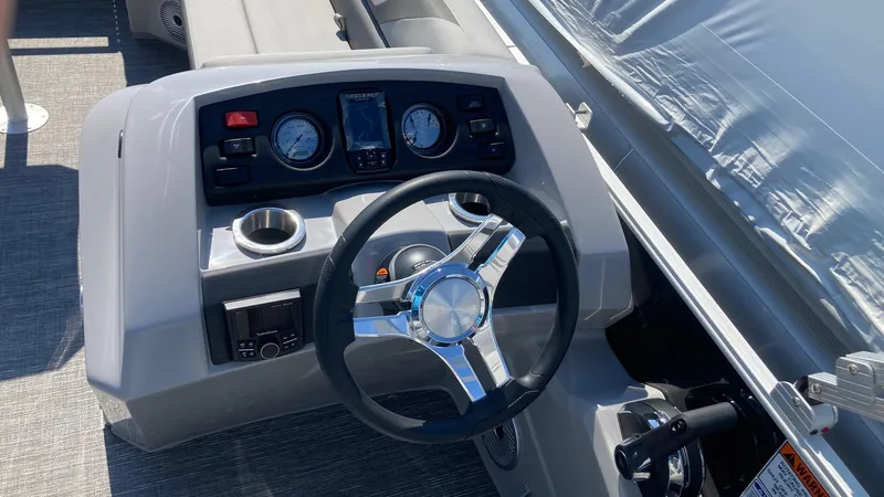 Slide: The Image of 2024 Bennington 21 SXSRC boat dashboard with steering wheel and instrument panel. - 5