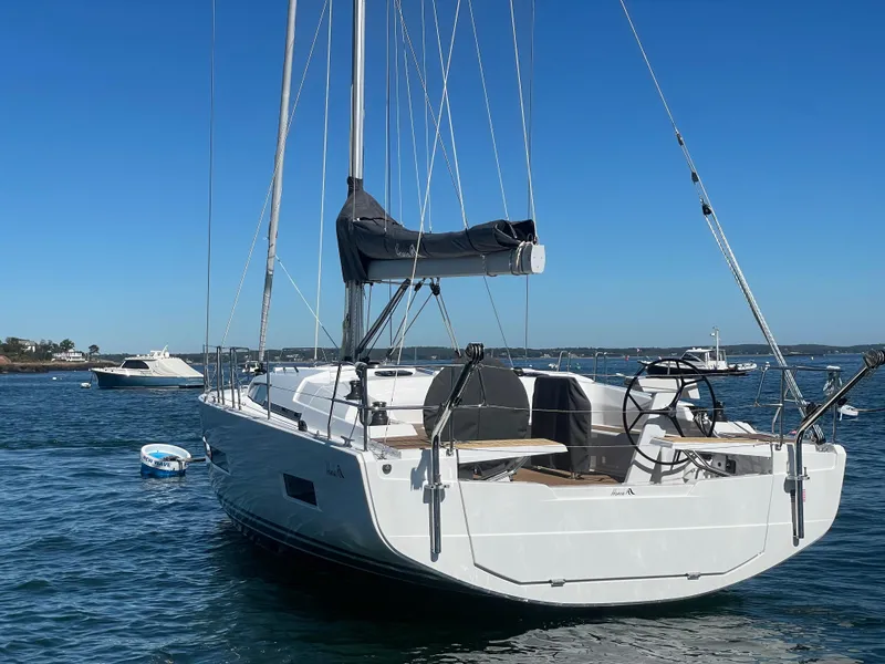 Slide: The Image of 2024 Hanse 410 sailboat on calm water under clear blue sky. - 11