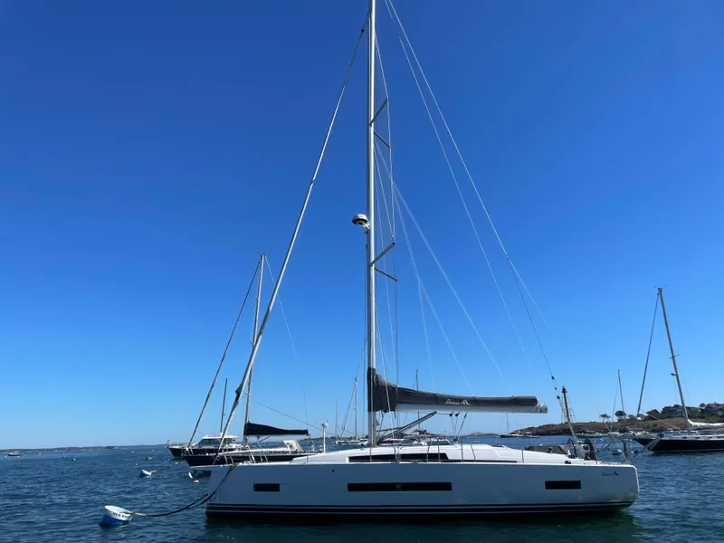 Slide: The Image of 2024 Hanse 410 sailboat on calm water under clear blue sky. - 12