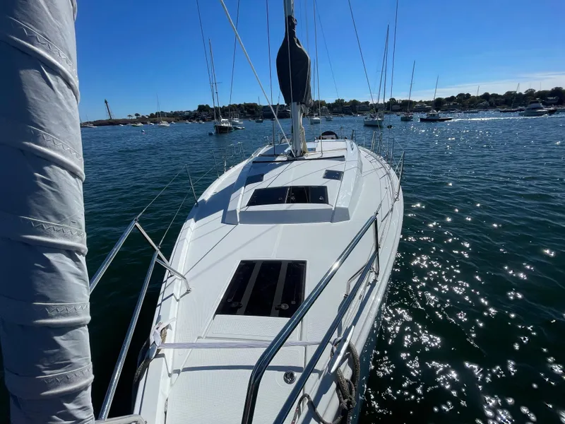 Slide: The Image of 2024 Hanse 410 sailboat on sparkling water, sunny day, marina background. - 13