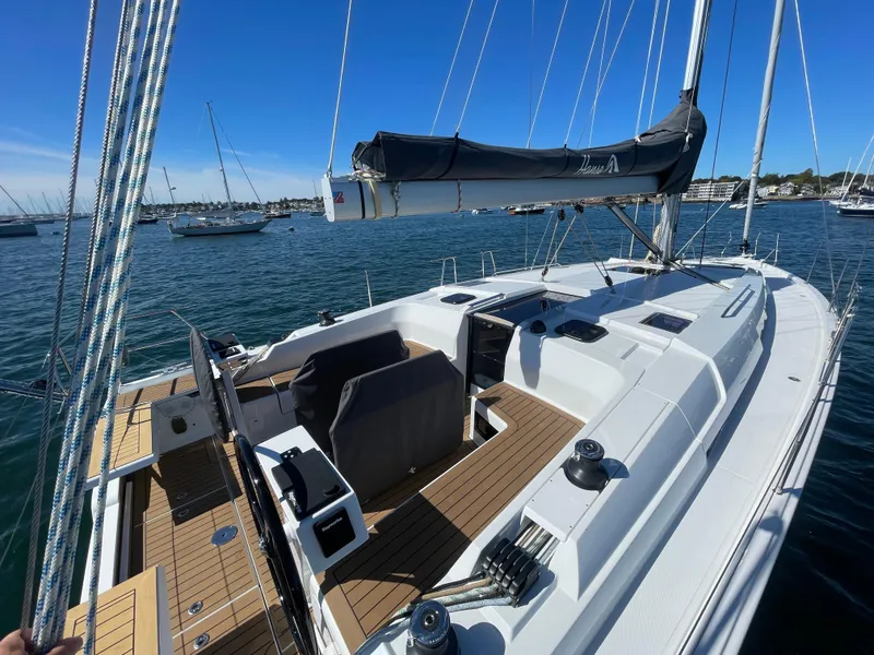 Slide: The Image of 2024 Hanse 410 sailboat on calm water, featuring sleek deck design and modern rigging. - 14