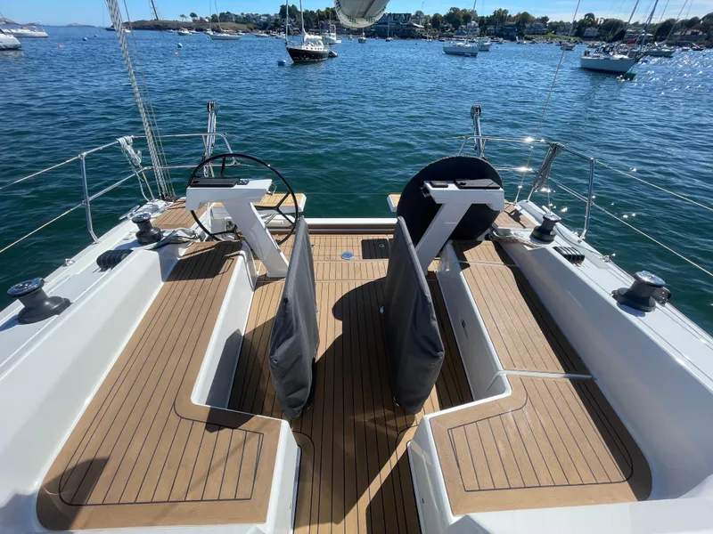 Slide: The Image of 2024 Hanse 410 yacht cockpit with dual steering wheels and teak decking. - 16