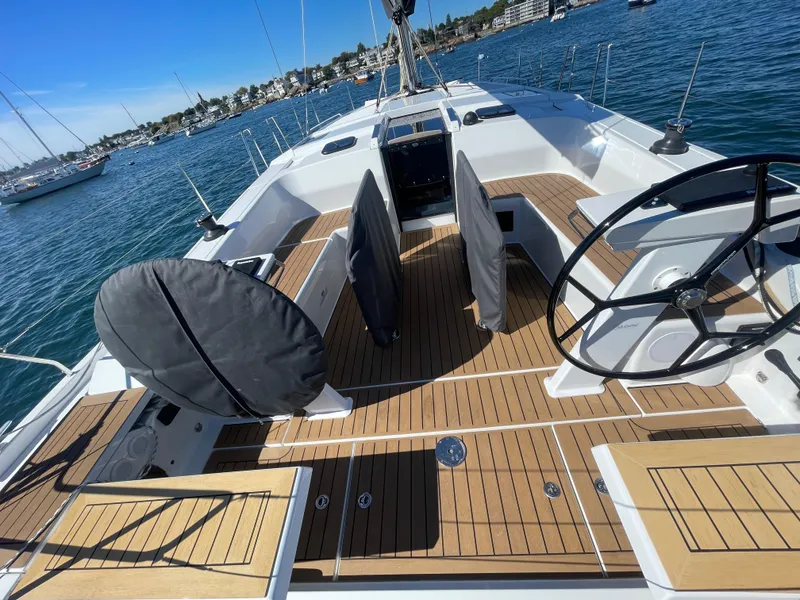 Slide: The Image of 2024 Hanse 410 yacht with sleek deck design and dual steering wheels. - 17