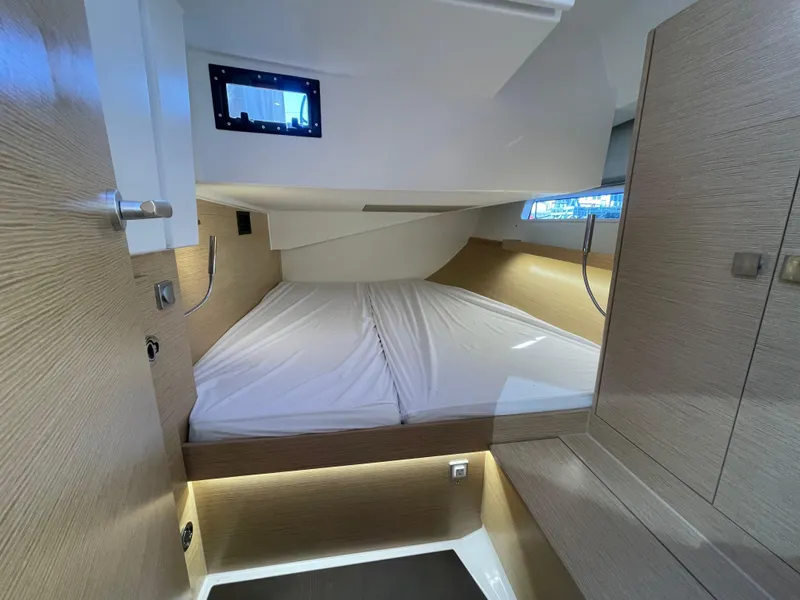 Slide: The Image of 2024 Hanse 410 yacht cabin with modern design and cozy bedding. - 20
