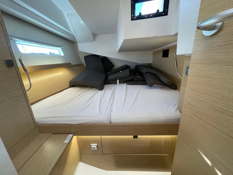 Slide: The Image of 2024 Hanse 410 yacht cabin with modern design and comfortable bedding. - 21
