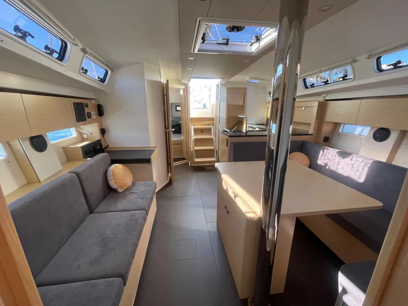 Slide: The Image of 2024 Hanse 410 yacht interior with modern seating and dining area. - 25