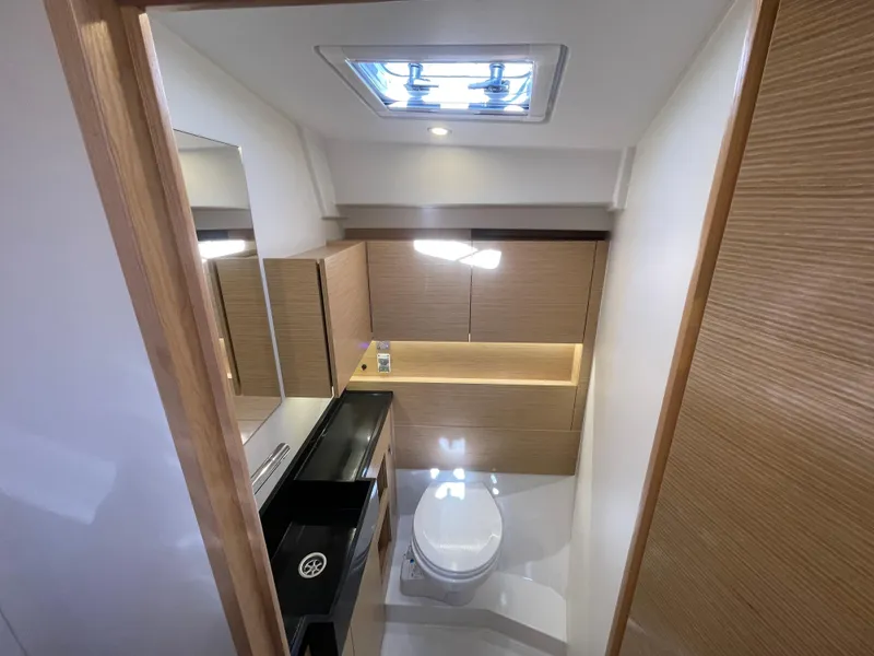 Slide: The Image of Modern bathroom interior of 2024 Hanse 410 yacht with wood accents and skylight. - 26