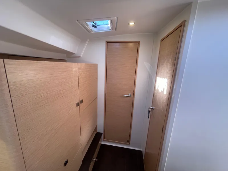 Slide: The Image of 2024 Hanse 410 yacht interior with wooden cabinetry and doors. - 27