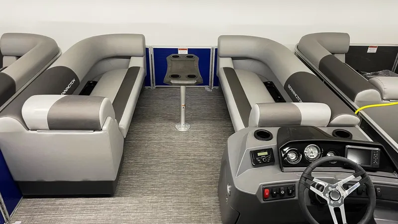 Slide: The Image of 2024 Bennington 20 SVSR pontoon boat interior with gray seating and steering console. - 2